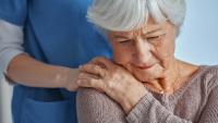 Nurse consoling a senior patient